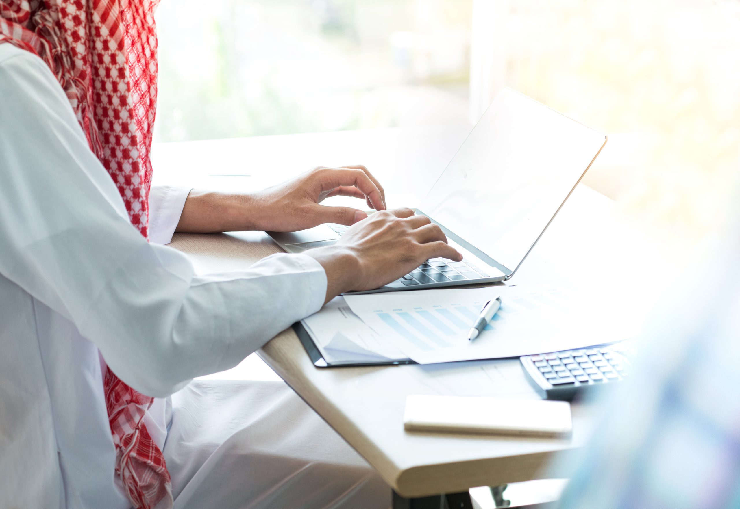 arabic business person working on laptop in office